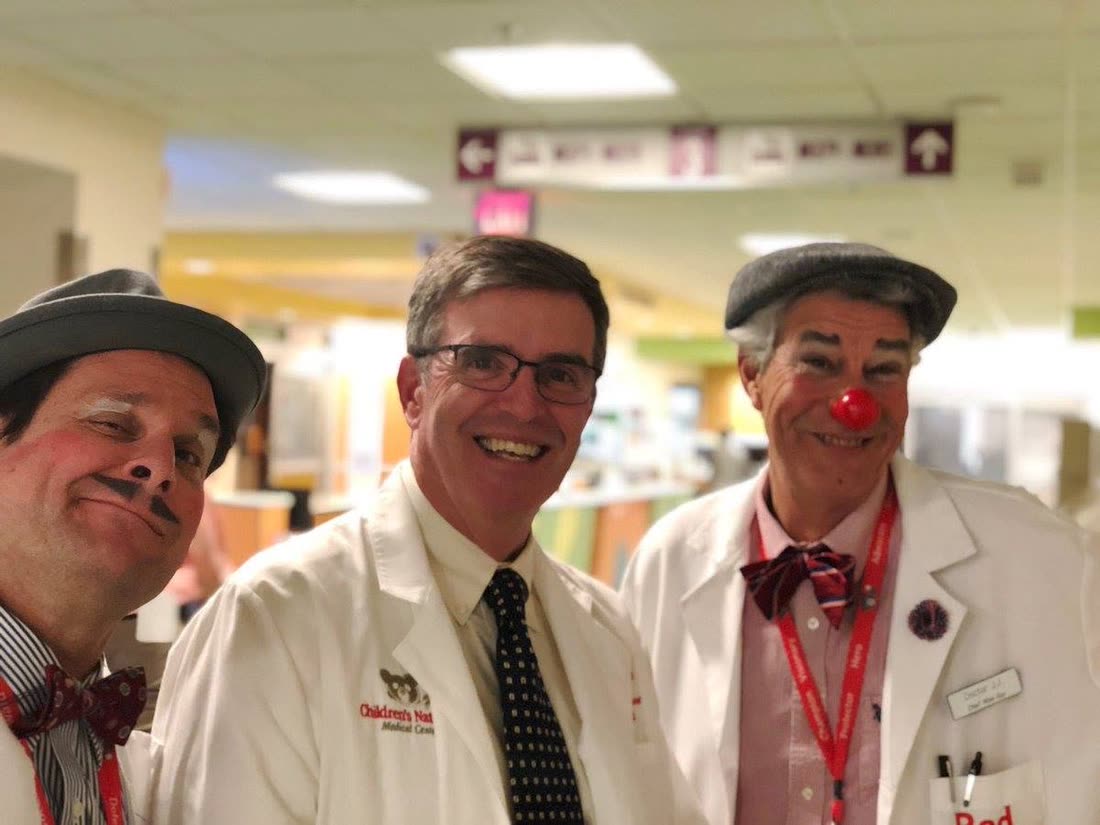 Two Red Nose Docs either side of a Children&rsquo;s National physician on the ward.